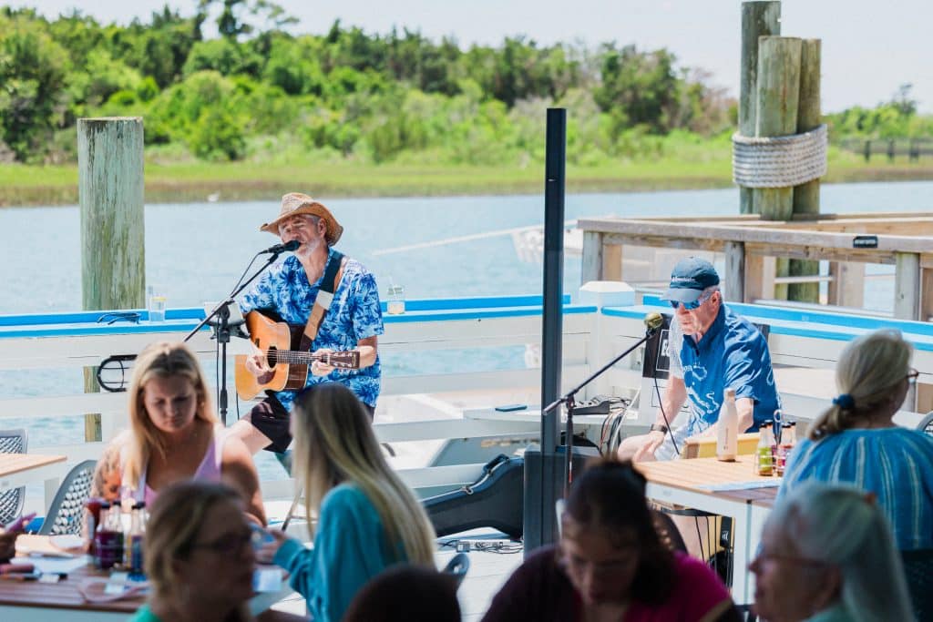 2 Musicians playing music ocean-side at Tower7 Restaurant