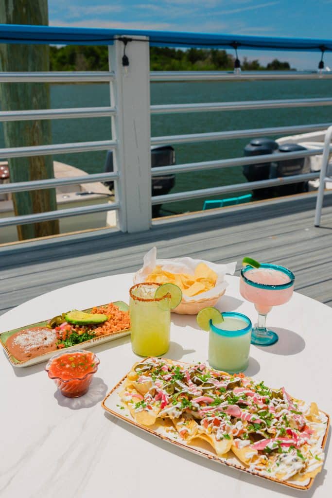 A colorful spread of Tower7 Restaurant Menu items including starters and cocktails.