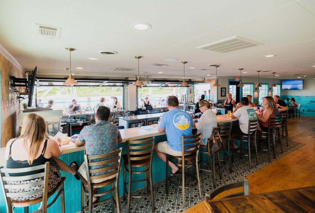 Patrons enjoying Cocktails and Food at the beautiful Tower7 Restaurant Open Air Bar